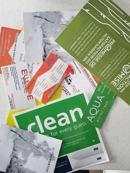 Assorted printed business cards, postcards and flyers for different customers