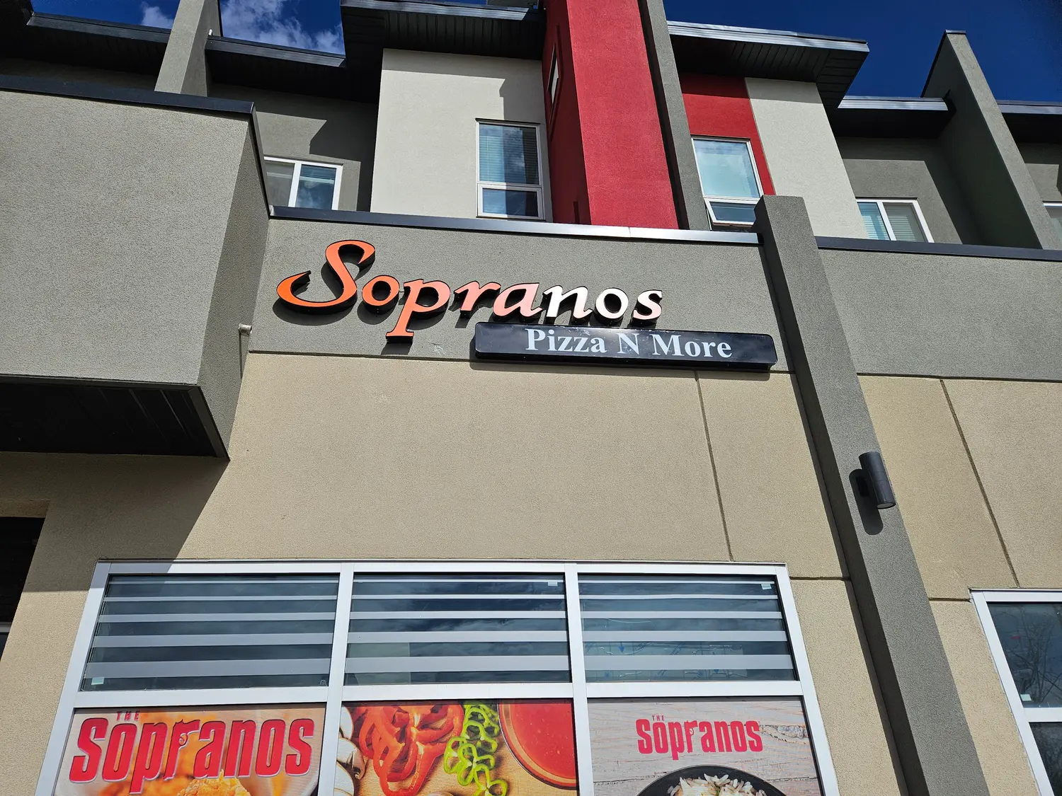 Sopranos Pizza N More channel letters and sign box on a stucco building