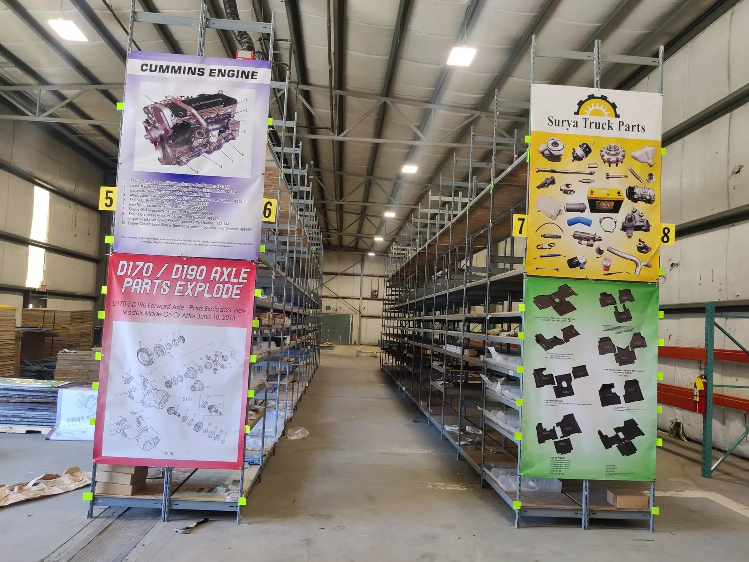 Printed product banners hung on warehouse racking at Surya Truck Parts