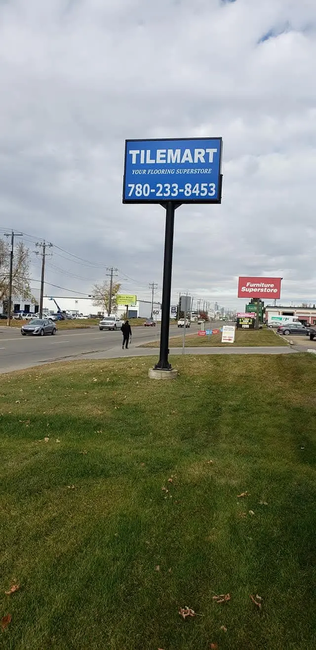 Tilemart single-post pylon sign beside a busy road